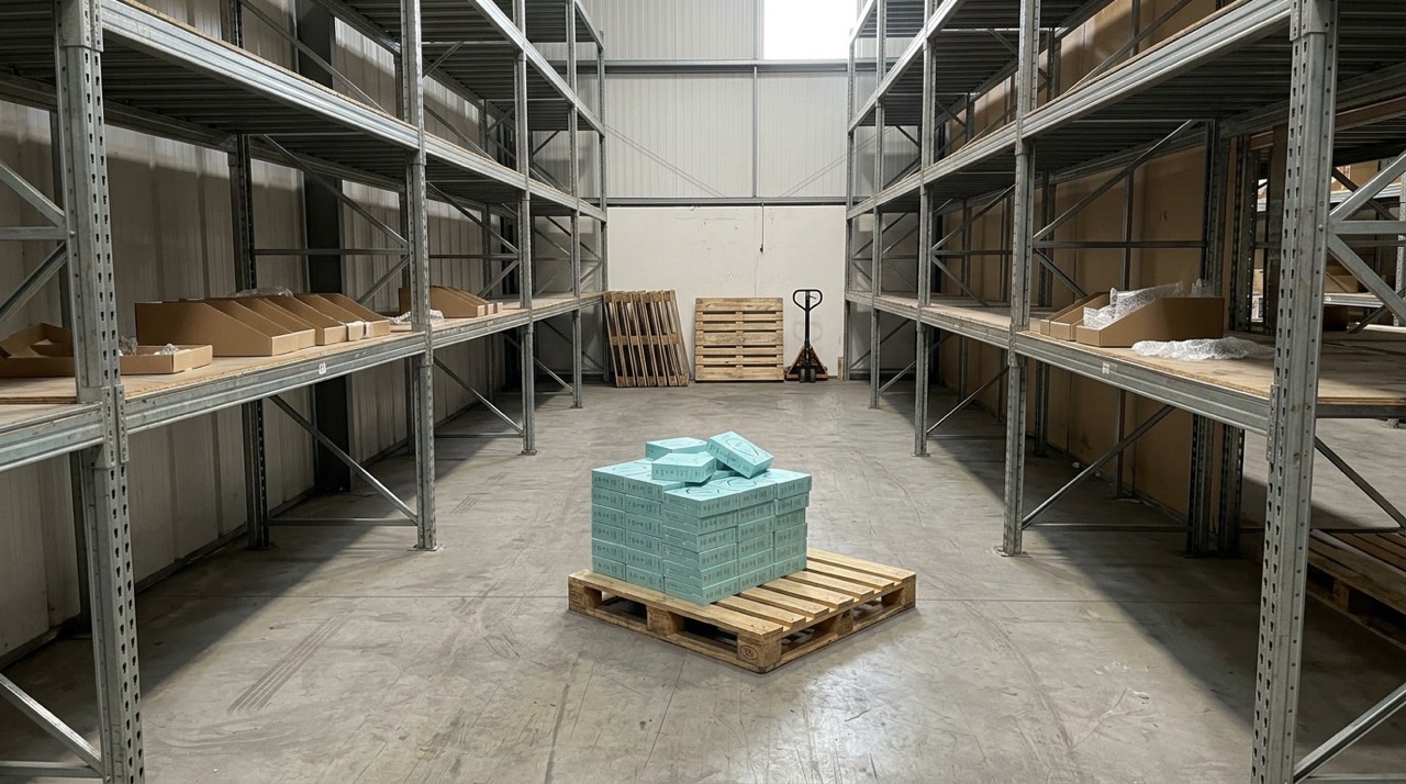 A limited pallet of Aurivo ReHears boxes in a nearly empty warehouse.